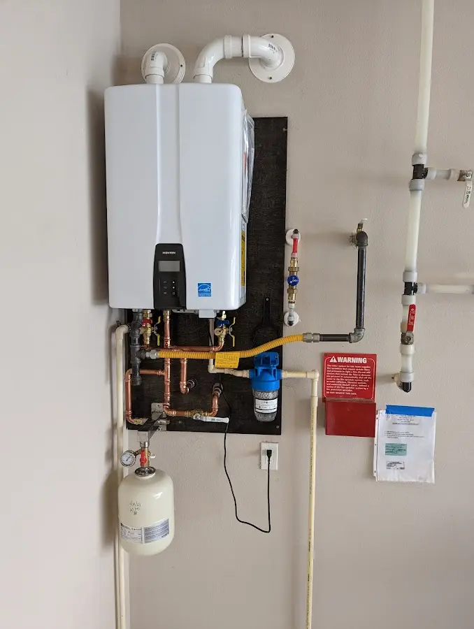 Professional plumber installing copper piping in a Kingstowne home